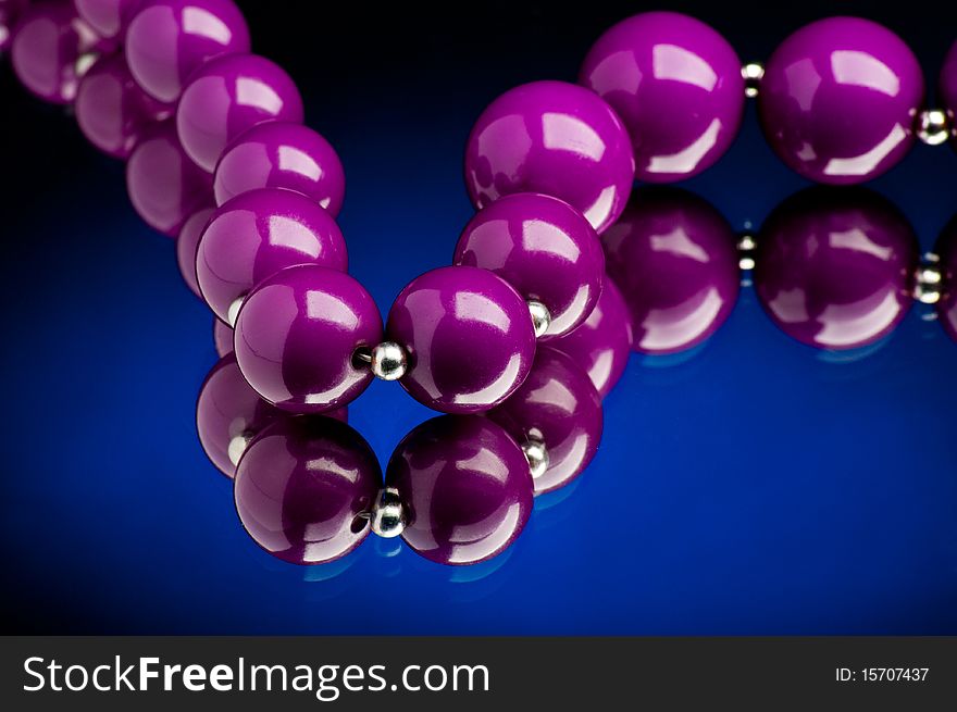 Purple pearls with blue background