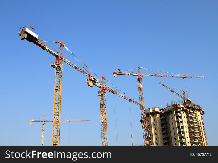 Cranes against a background of blue sky