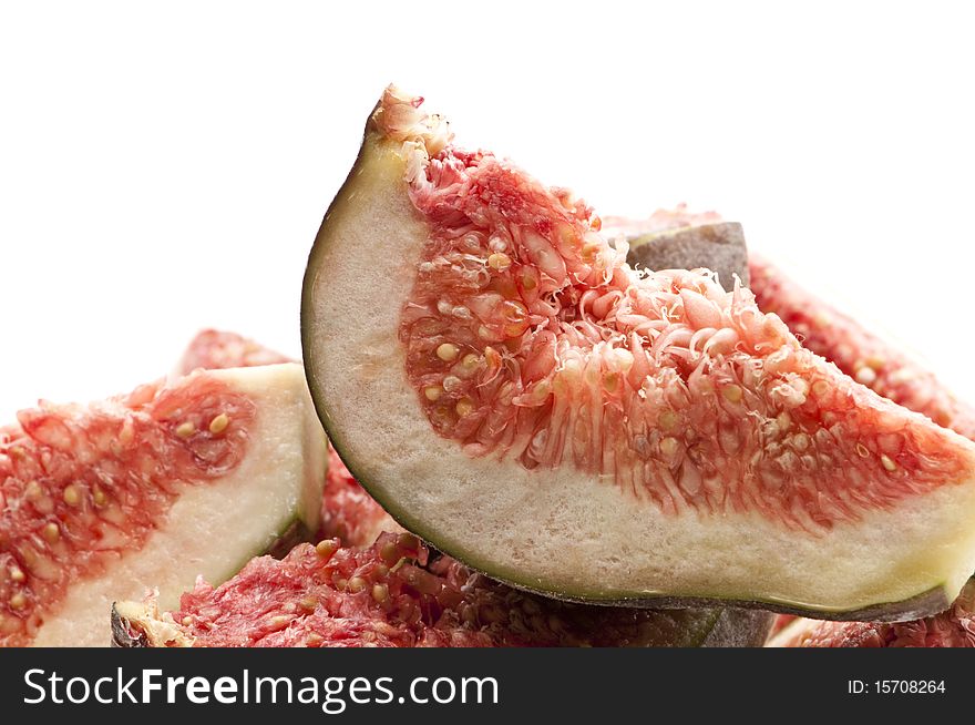 Sliced figs on top of each other against a white isolated background.
