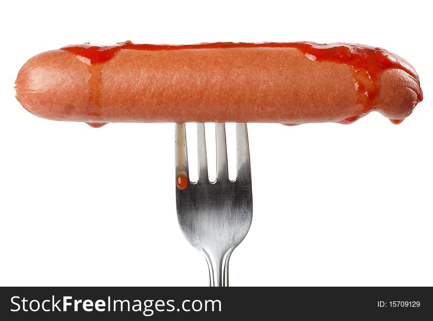 Sausage with tomato sauce on the fork isolated over white background. Sausage with tomato sauce on the fork isolated over white background