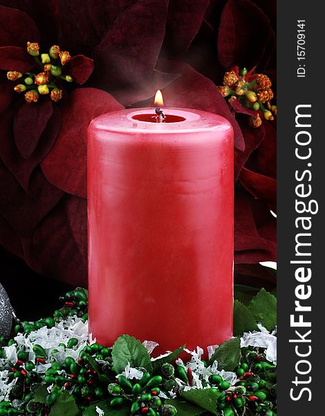 Lit Christmas Candle And Poinsettias