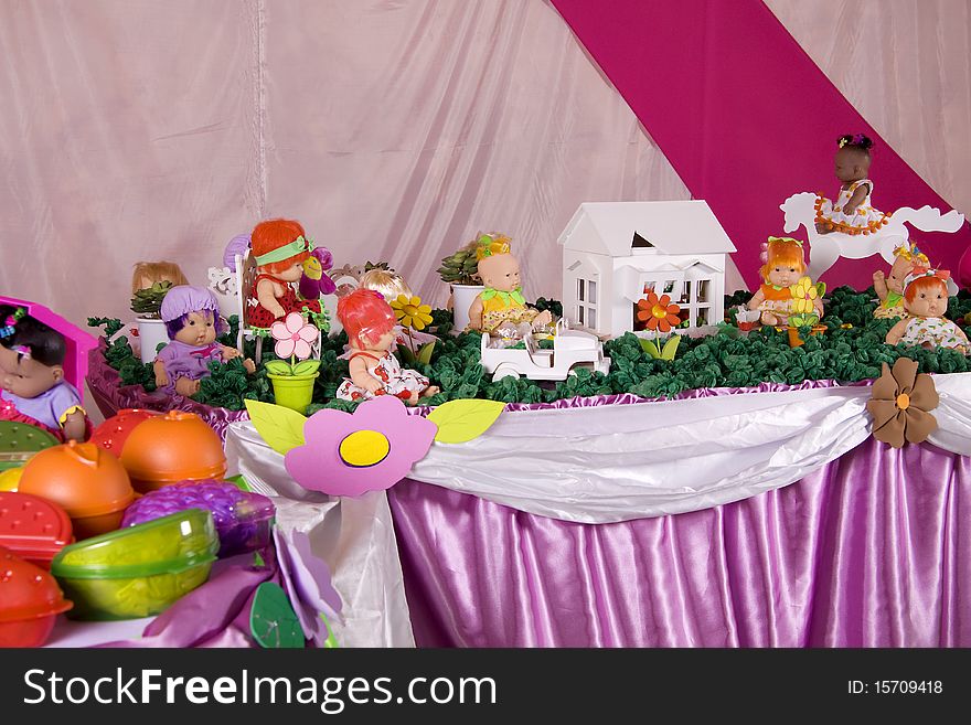 Table full of dolls and toys for children. Table full of dolls and toys for children