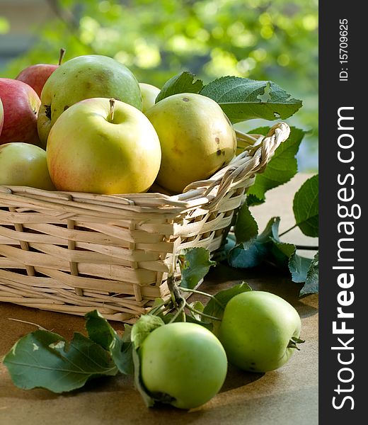 Fresh ripe apples in basket  on table