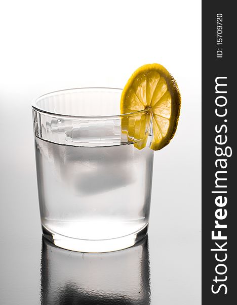 Glass of ice water with a lemon slice