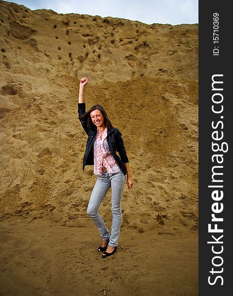 Successful woman with raised her hand with landscape background