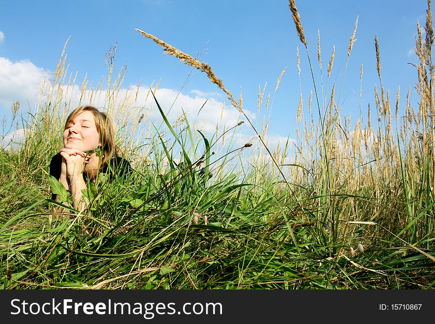 Young and nice woman in  grass.