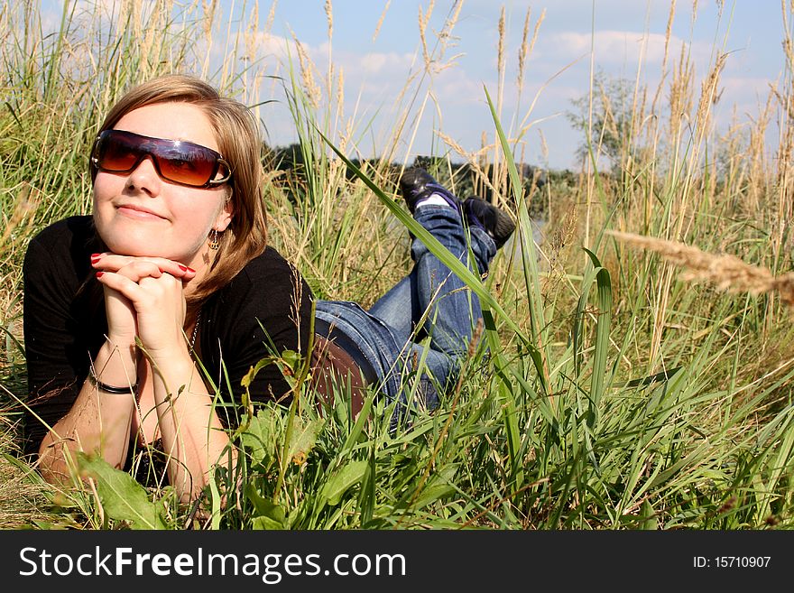 Young and nice woman in grass.