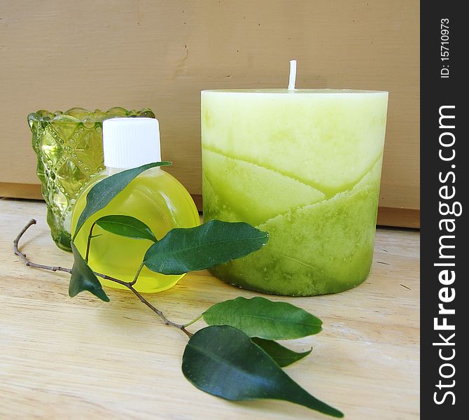 Big candle, soap bottle, leafs and votive candle. Big candle, soap bottle, leafs and votive candle