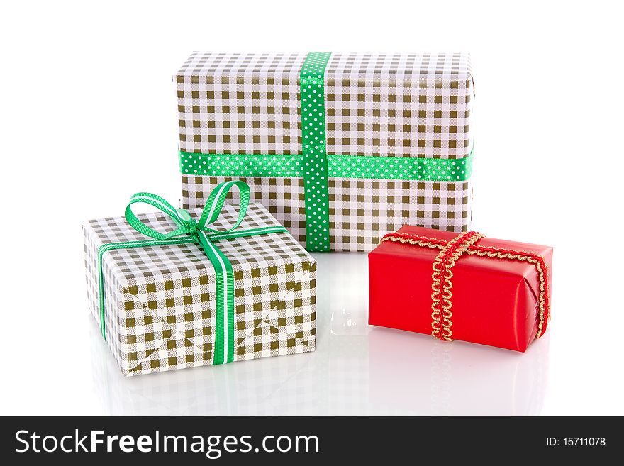 Green checkered presents and a red gift isolated over white. Green checkered presents and a red gift isolated over white