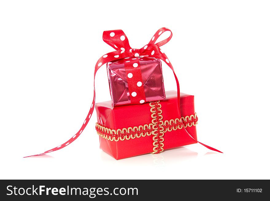 Two red stacked presents with gift ribbons isolated over white. Two red stacked presents with gift ribbons isolated over white