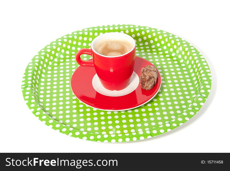 A dotted tray with a cup of coffee and a truffle isolated over white. A dotted tray with a cup of coffee and a truffle isolated over white