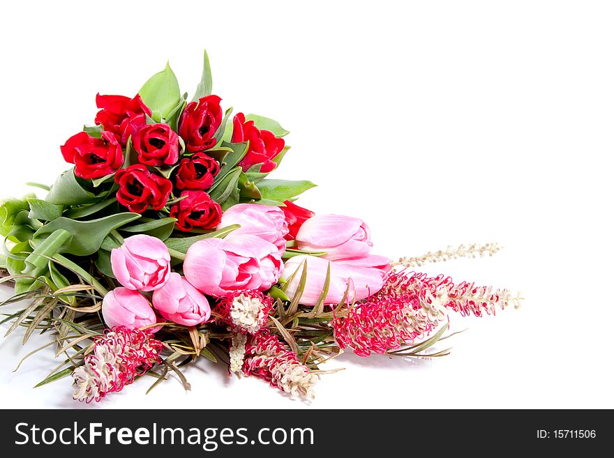 A colourfully bouquet with pink and red tulips isolated over white. A colourfully bouquet with pink and red tulips isolated over white