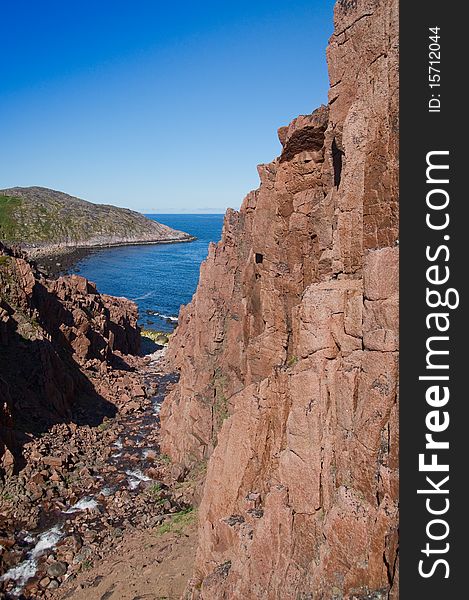 Coast of Kola Peninsula. Teriberka. Barents Sea. Brook flows from tarn.