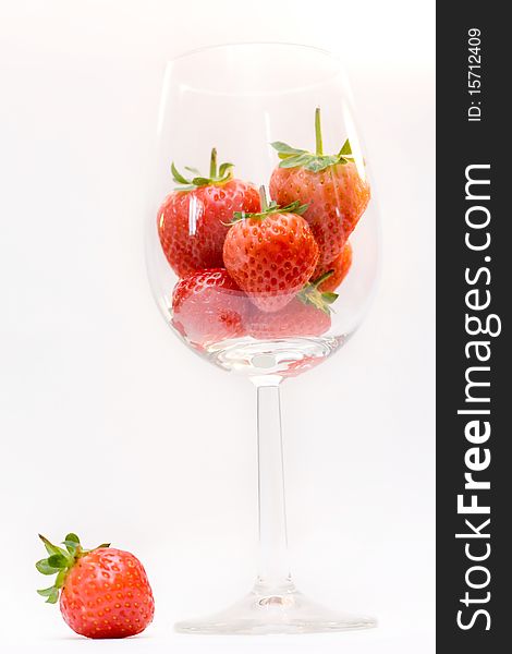Strawberries in the wine glass isolated on white. Strawberries in the wine glass isolated on white