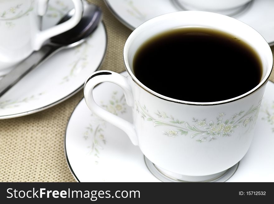 A porcelain cup filled with hot aromatic coffee. A porcelain cup filled with hot aromatic coffee