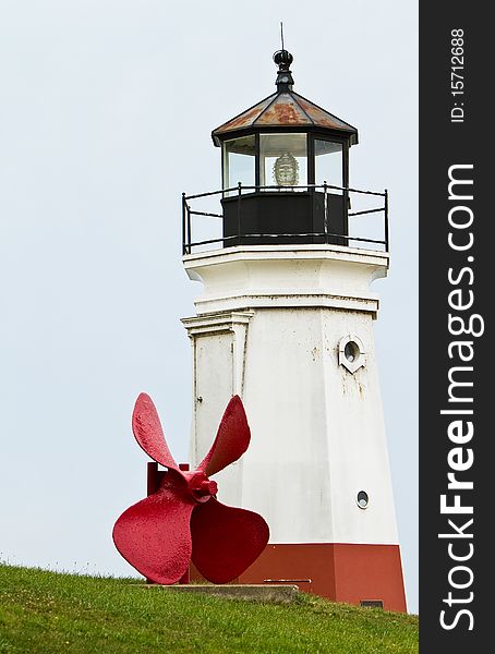 Propeller in front of a lighthouse. Propeller in front of a lighthouse