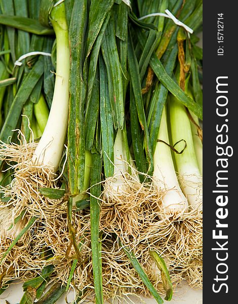 Bunches of green onions for sale at a farmer's market. Bunches of green onions for sale at a farmer's market
