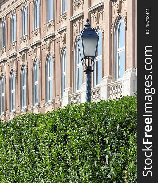 Street lights and building facade details and hedges. Street lights and building facade details and hedges.