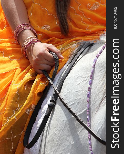 Krishna devotee with a white horse with reins. Krishna devotee with a white horse with reins.