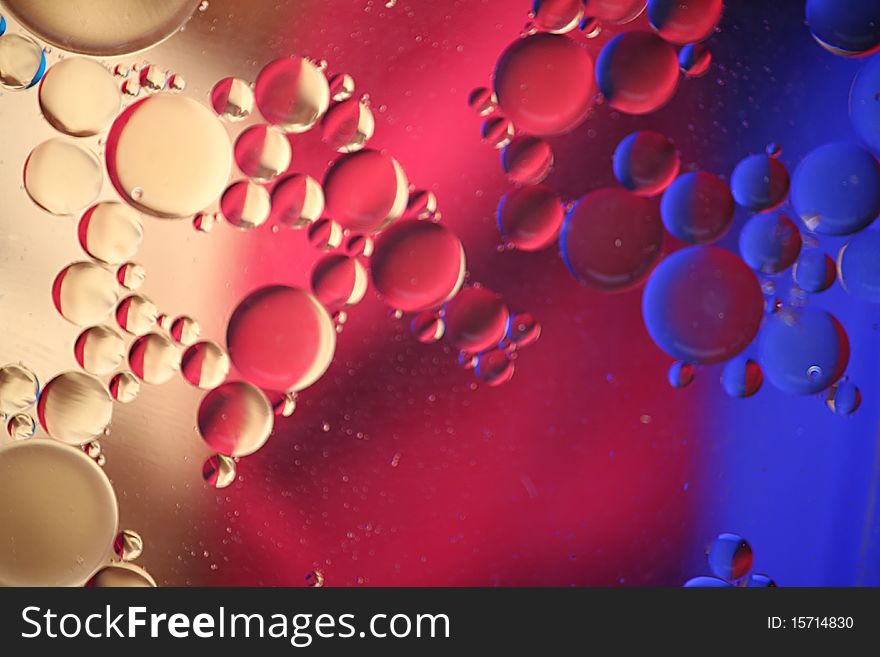 Oil bubbles with blue, red and yellow color reflection