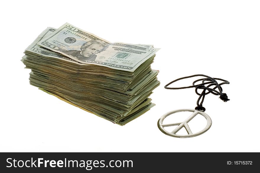 US Currency Twenty Dollar Bills  Stacked next to a peace sign necklace, isolated on white background. US Currency Twenty Dollar Bills  Stacked next to a peace sign necklace, isolated on white background.