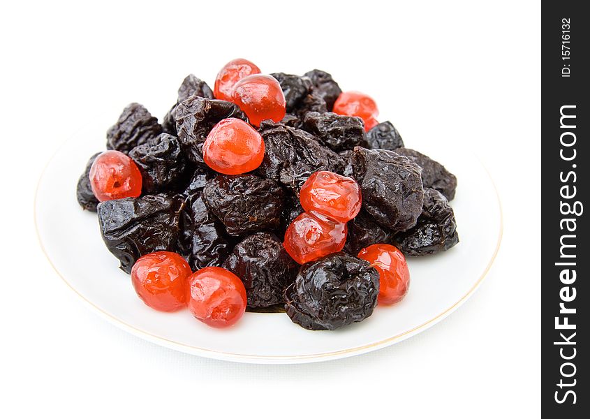 Healthy food with dried prunes and cherries on a plate. Isolated over white background. Healthy food with dried prunes and cherries on a plate. Isolated over white background.