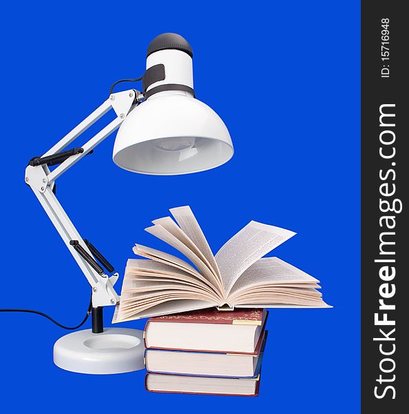 Table lamp with books on a blue background