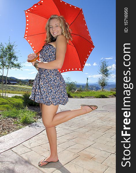 Young teenager with red umbrella in the mountains. Young teenager with red umbrella in the mountains.