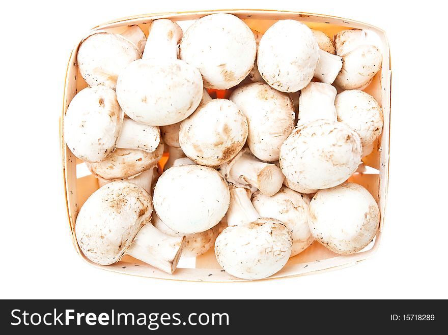 Raw mushrooms in box on white background