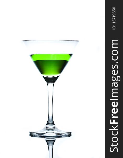 Green drinks in martini glass on white background with reflection