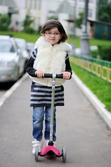 Nice Litlle Girl With Pink Scooter Stock Photos