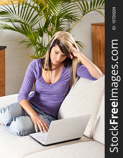 Woman in living room with a laptop. Woman in living room with a laptop