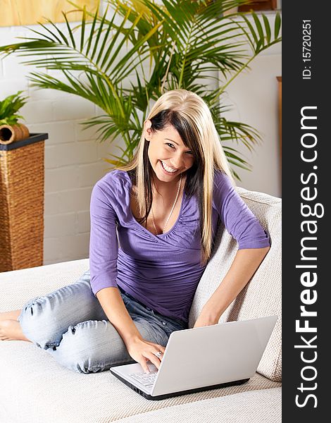 Woman in living room with a laptop. Woman in living room with a laptop