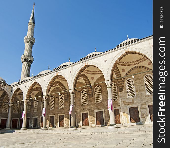 Inner courtyard with arches and minaret of the Sultanahmet Blue Mosque in Istanbul, Turkey. Inner courtyard with arches and minaret of the Sultanahmet Blue Mosque in Istanbul, Turkey