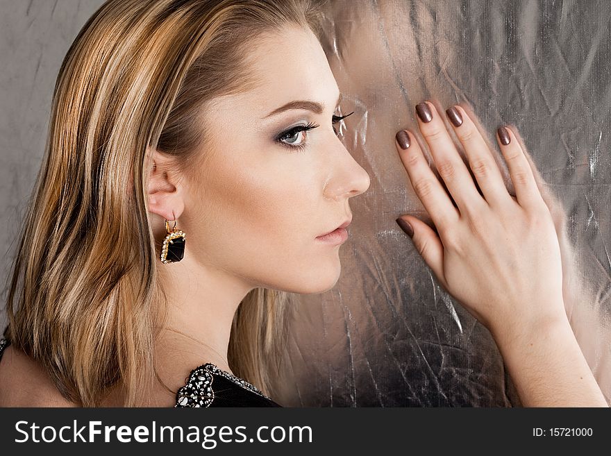 Beautiful fashioned woman on silver background