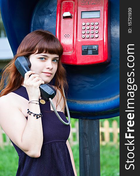 Young teenage girl in telephone box. Young teenage girl in telephone box