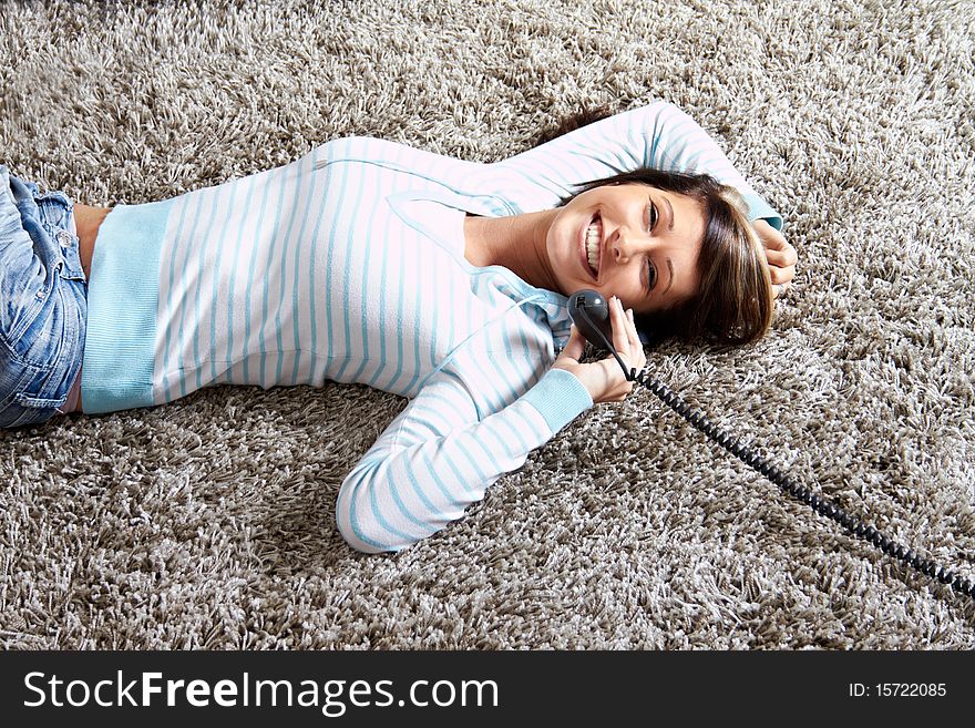 Woman in living room with a phone is calling. Woman in living room with a phone is calling