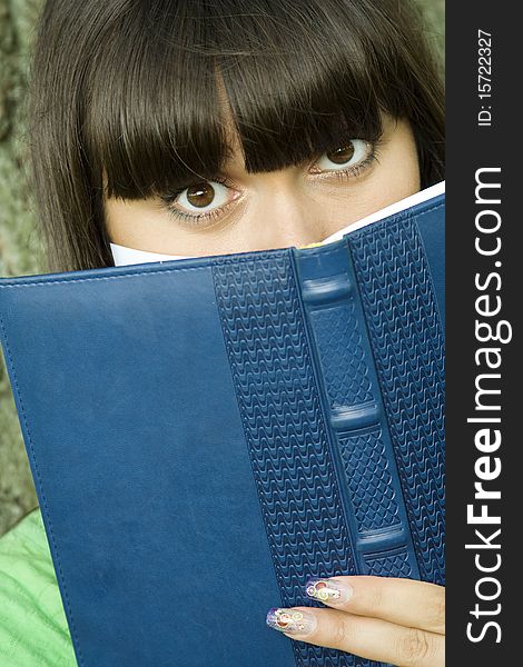 Female In A Park With A Notebook