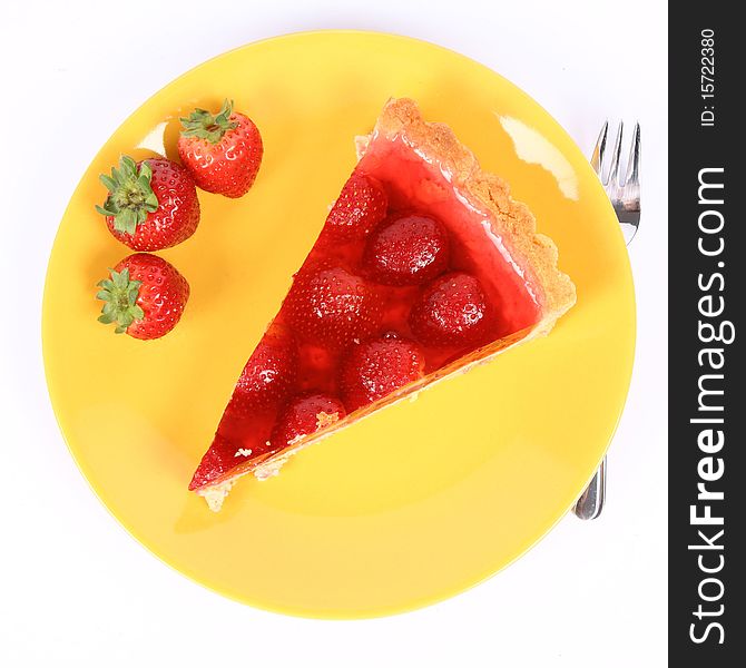 Piece of Strawberry Tart on a yellow plate decorated with strawberries, and a fork