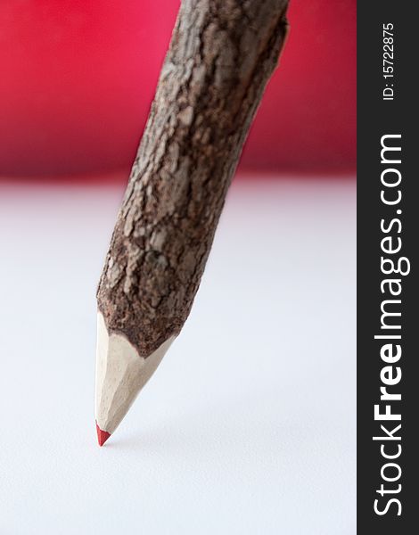 Red pencil isolated on white and red background