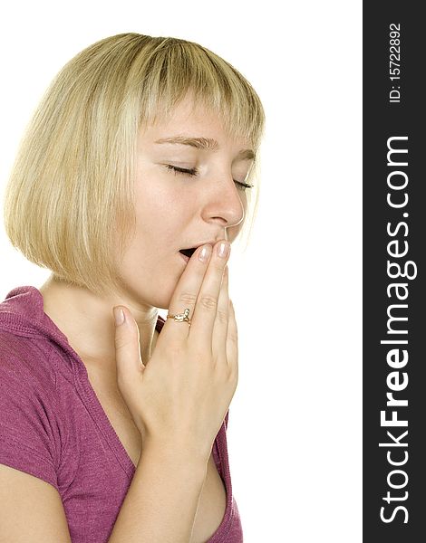 Girl yawns and covers her mouth with his hand. Isolated on white background