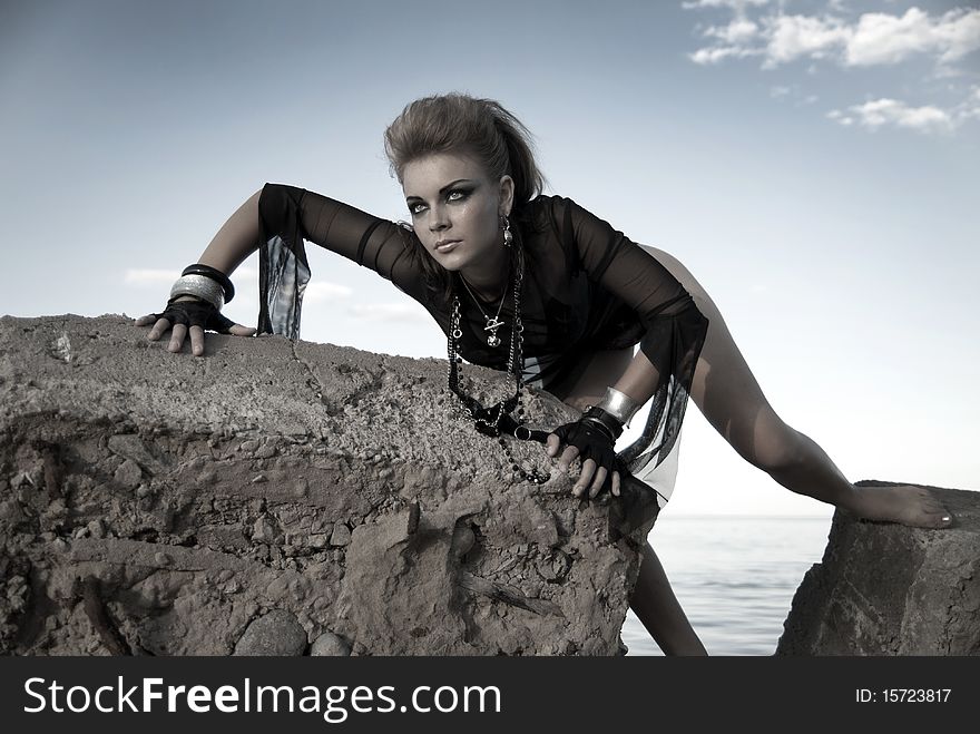 Rock girl on a concrete slab in an interesting position