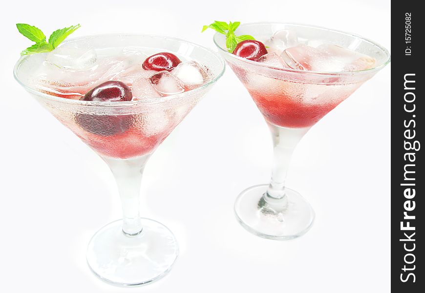 Alcohol red liqueur cocktail with ice and cherry two glasses. Alcohol red liqueur cocktail with ice and cherry two glasses