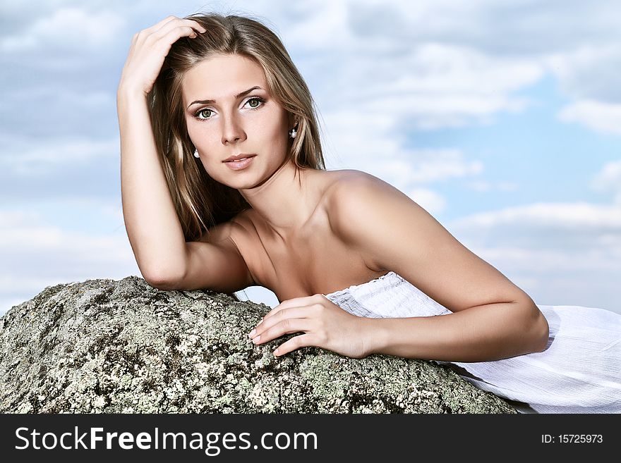Beautiful young woman posing over sea and mountains. Beautiful young woman posing over sea and mountains.