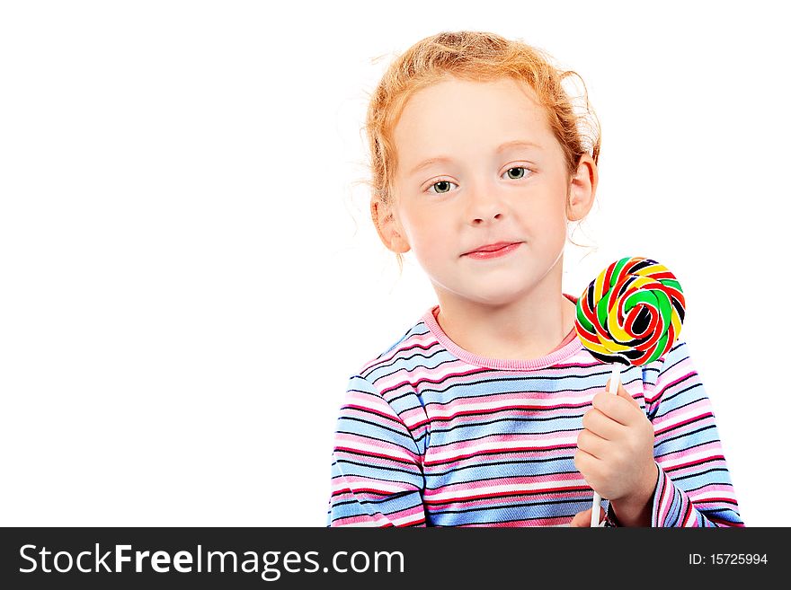 Portrait of a little red-haired girl licking lollipop. Isolated over white background. Portrait of a little red-haired girl licking lollipop. Isolated over white background.