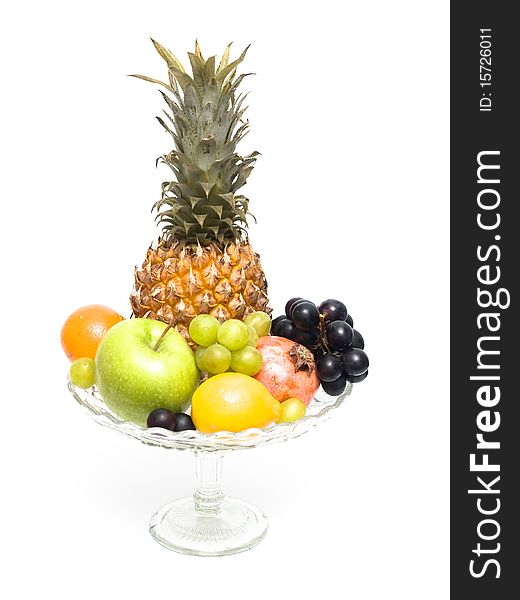 Group of different fruits in a glass vase on a white background. Group of different fruits in a glass vase on a white background
