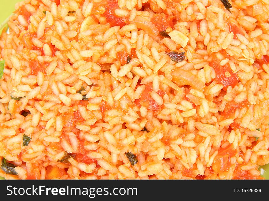 Food background: Risotto with tomatoes in close up