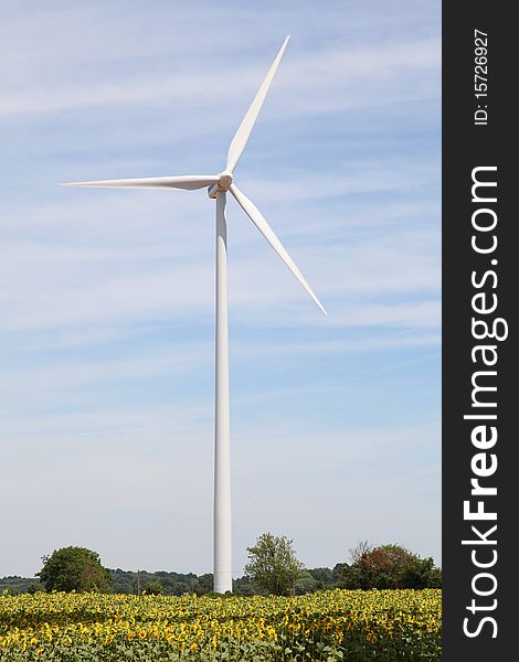 View of wind turbine in blue sky. View of wind turbine in blue sky