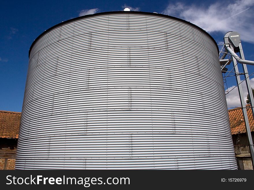 Metal silo on a farm for storing grain. Metal silo on a farm for storing grain.