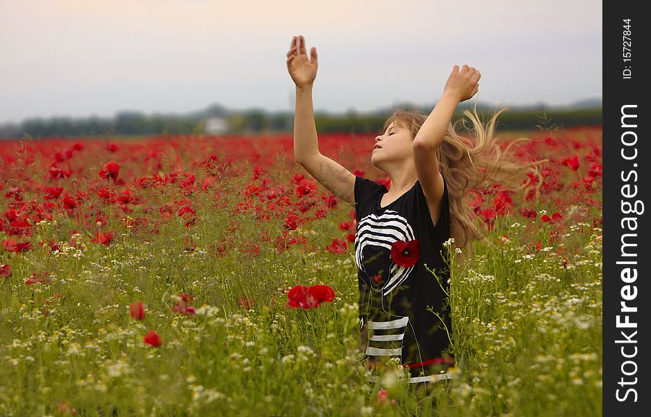 Child with long blond hair in the poppie Field. Child with long blond hair in the poppie Field